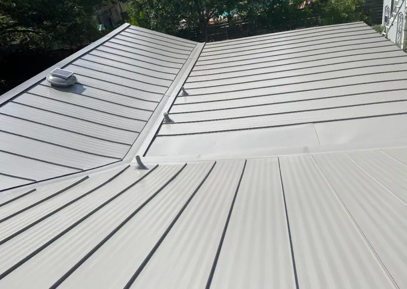 Solar attic fan installed on a metal roof for Roof Ventilation in Silsbee